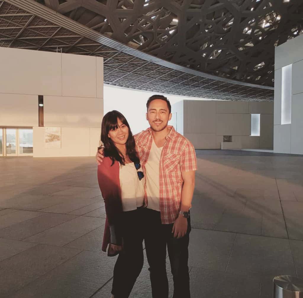 Two people standing together at the Louvre in Dubai