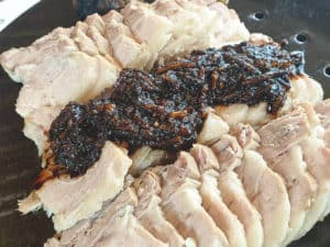 Boiled pork topped with black garlic from Korea