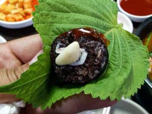 Jeonju Korean blood sausage on perilla leaf with garlic