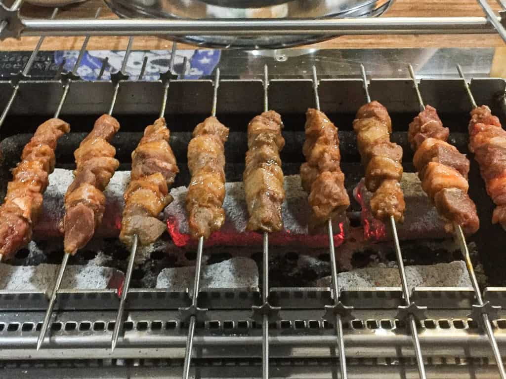 Yang koji or lamb skewers on a rotating grill