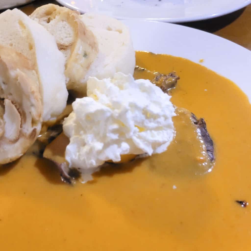 A closeup of beef tenderloin with pork and cream sauce