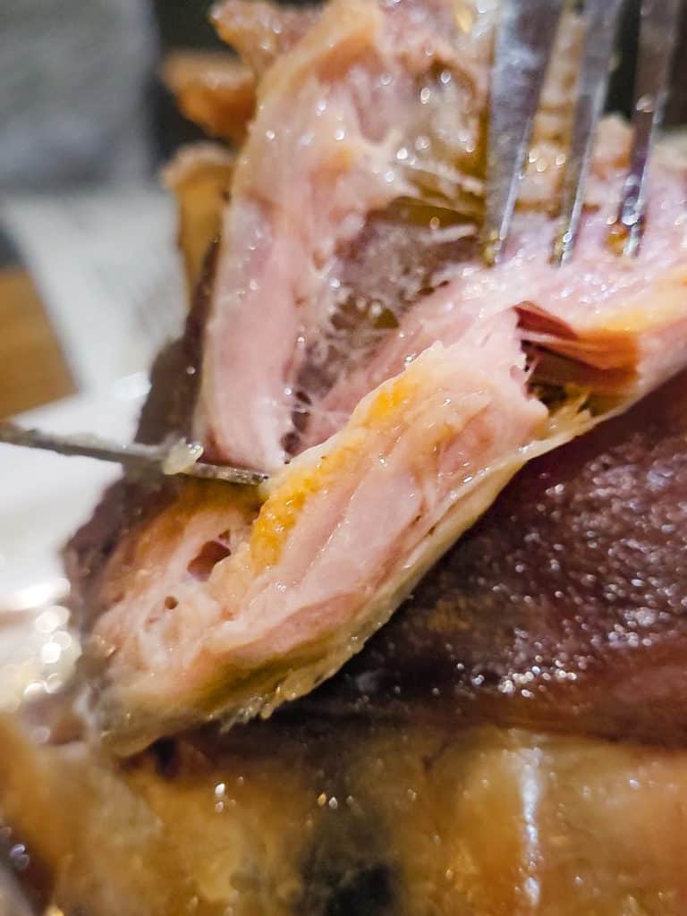 A closeup of a slice of pork knuckle at Bredovský Dvůr in Prague