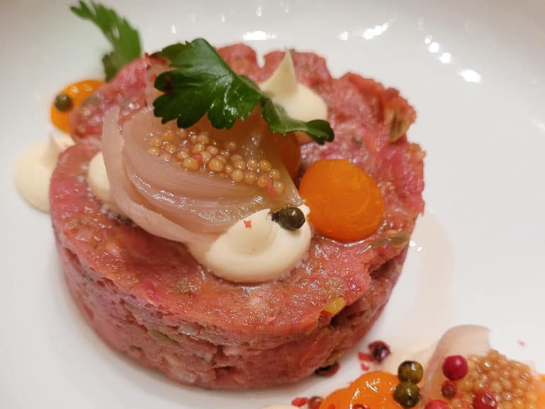Beef tartare with sauce and vegetables