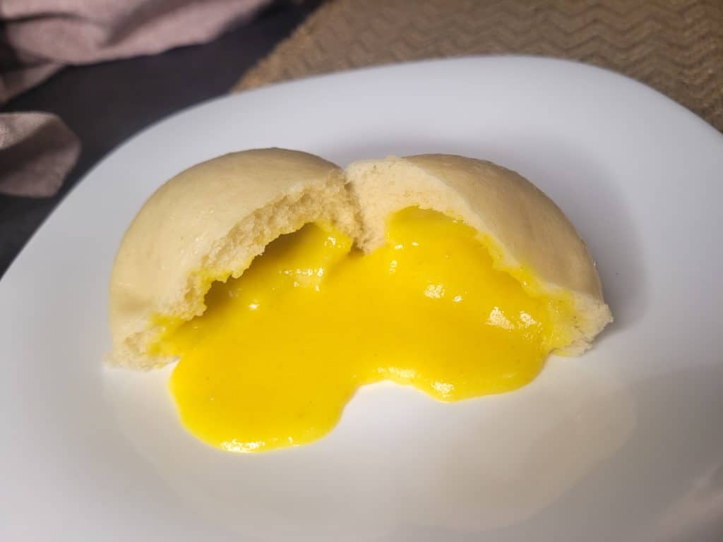 A closeup of salted egg yolk lava bun