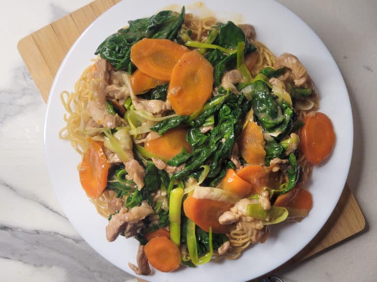 Plate of crispy pan friend noodles and vegetable topping