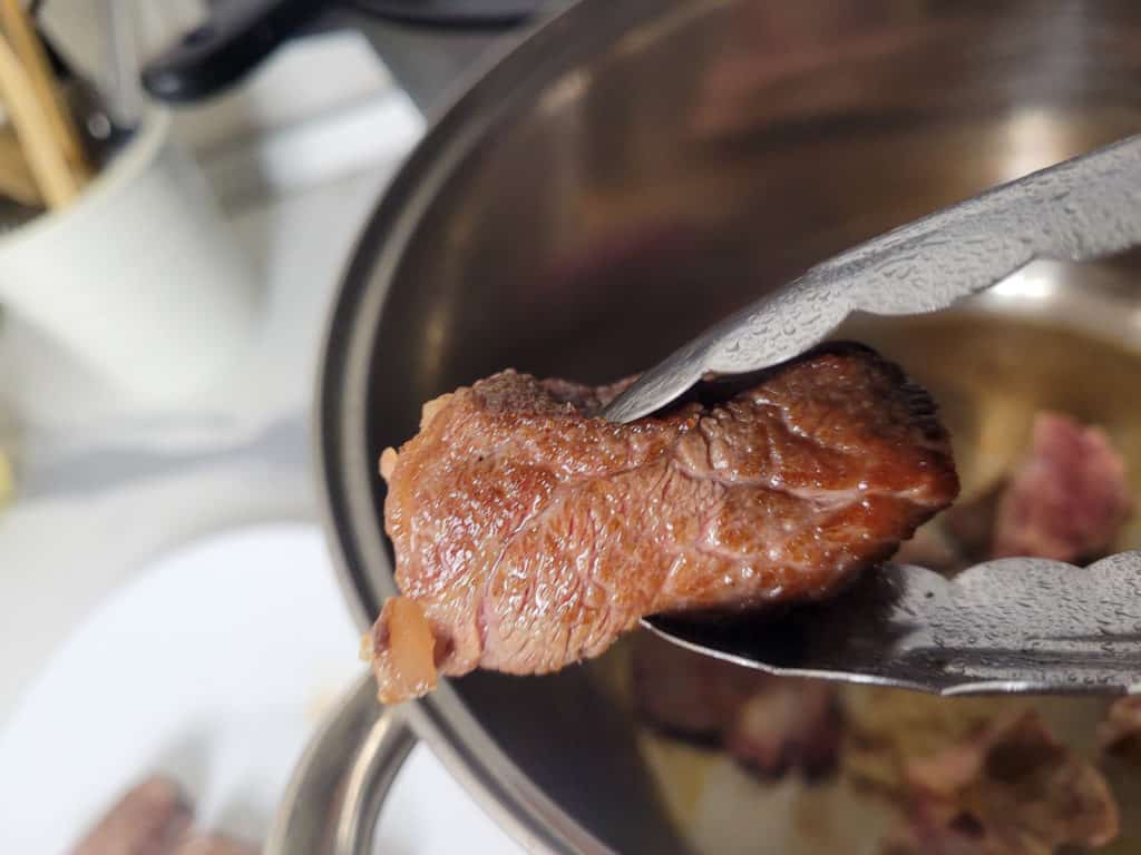 Closeup of browned beef from a pot