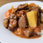 local style beef stew made with potatoes, tomatoes, celery and carrots on a plate