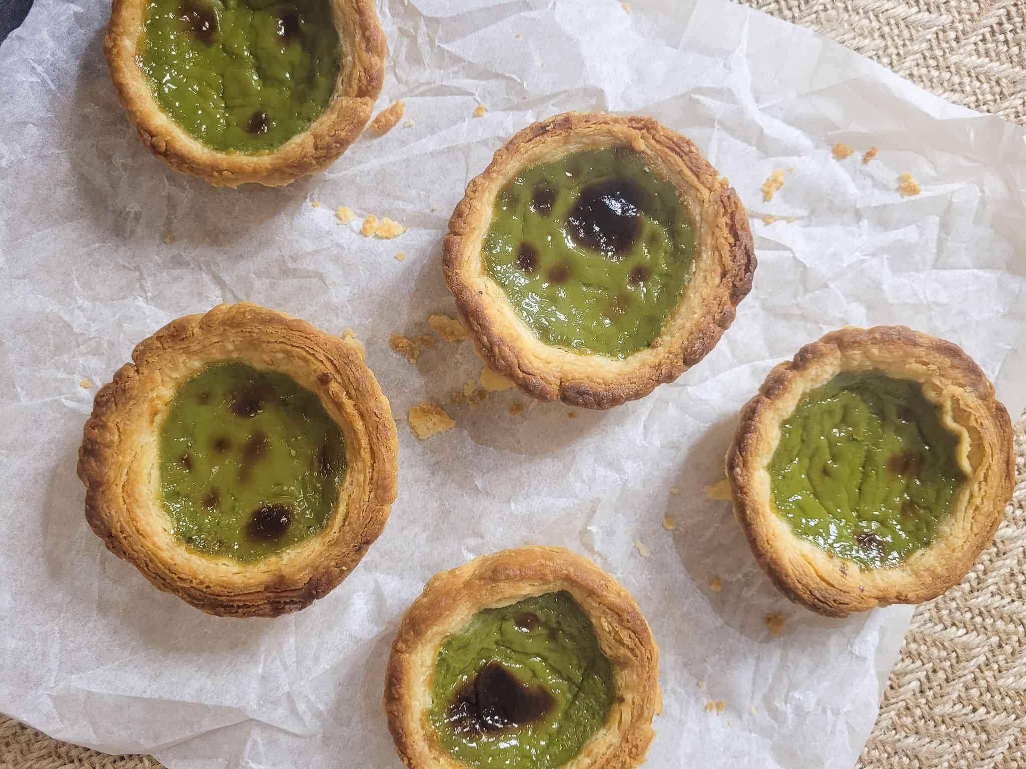 Overhead shot of matcha Portuguese egg tarts