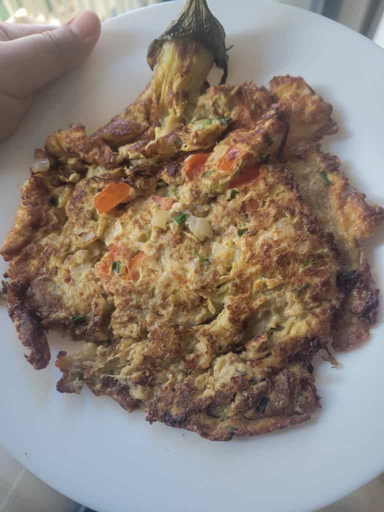 Vegetable filled tortang talong on a white plate