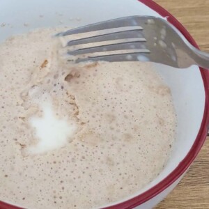 Checking for bubbles on yeast in a bowl of milk