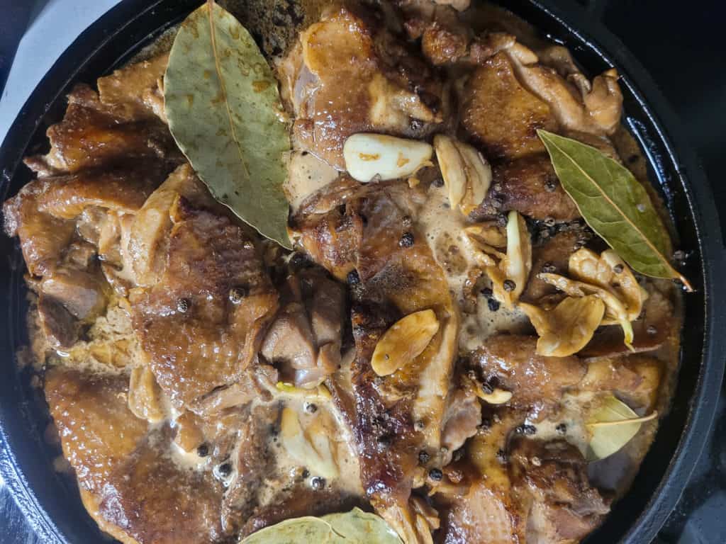 Chicken adobo in cast iron with seasonings