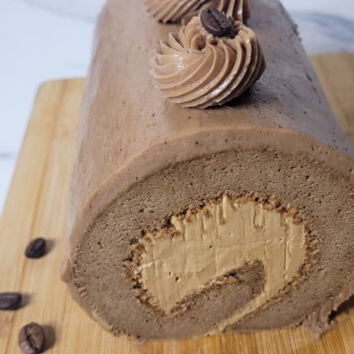 Mocha cake roll on a wooden board