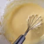 Filipino-style coconut macaroon batter with whisk in bowl