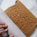 Sponge cake being rolled with wax paper
