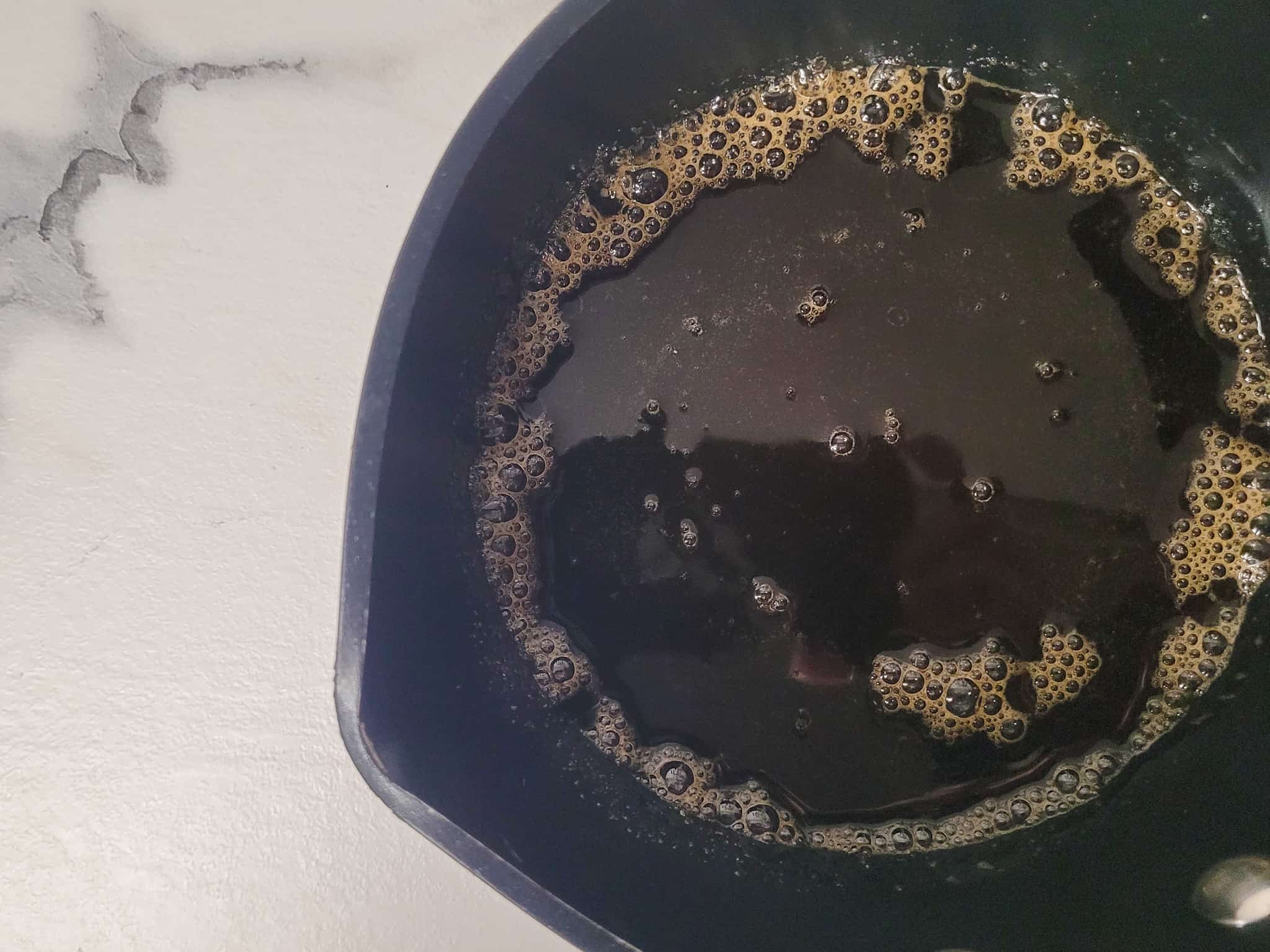 Coffee sugar syrup in a black pot