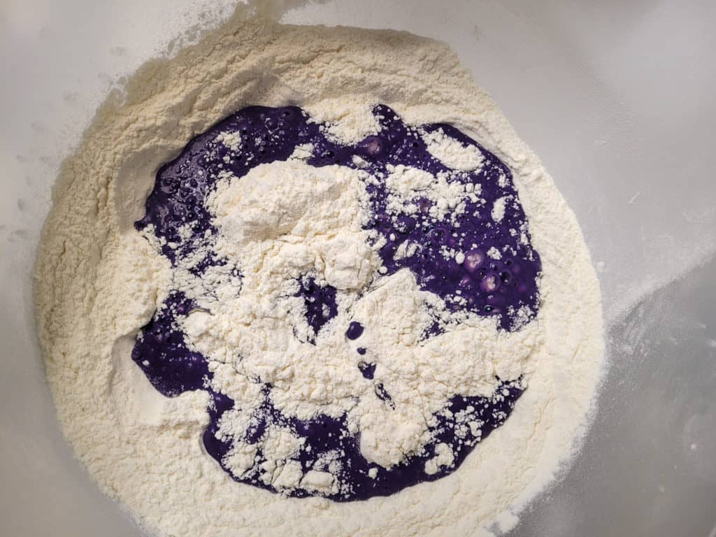 Ube pandesal yeast mix with dry ingredients in a bowl