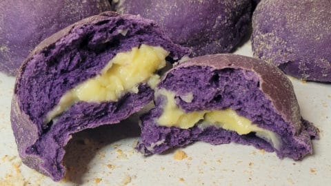 Cross section of ube pandesal in front of other buns