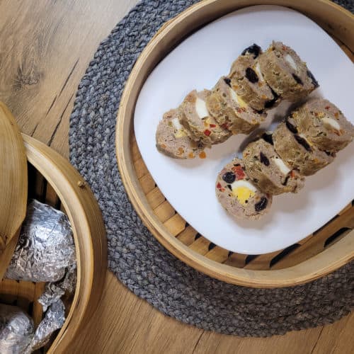 Overhead shot of sliced embutido or Filipino meatloaf in a bamboo steamer
