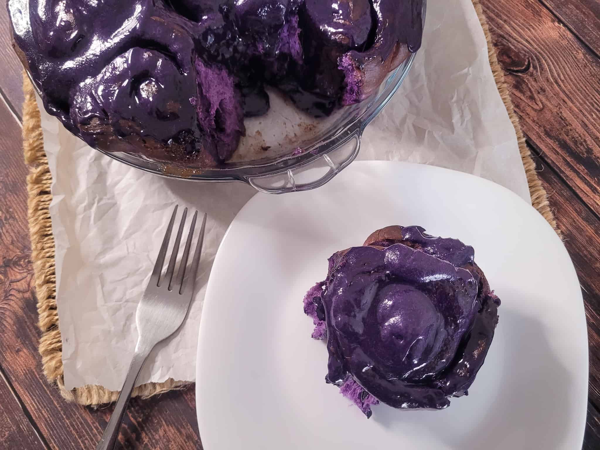 Ube cinnamon rolls on a wood table