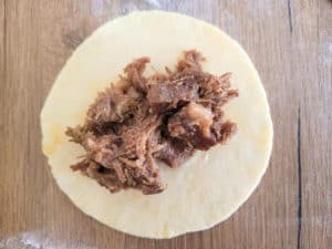 Meat on top of raw dough