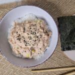 Canned spicy tuna bowl next to seaweed