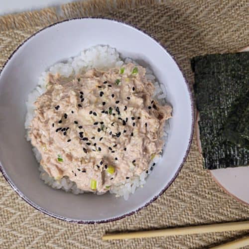Canned spicy tuna bowl next to seaweed