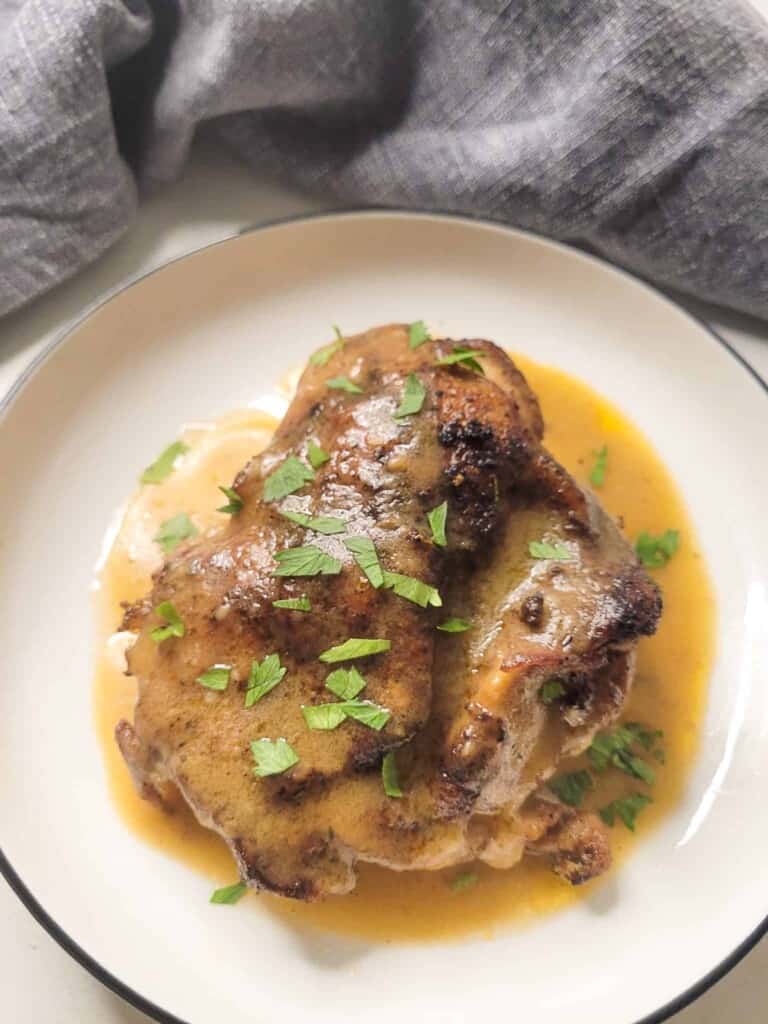 Cast iron chicken thigh in a small plate