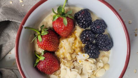 Closeup of oatmeal custard with fruits and almonds