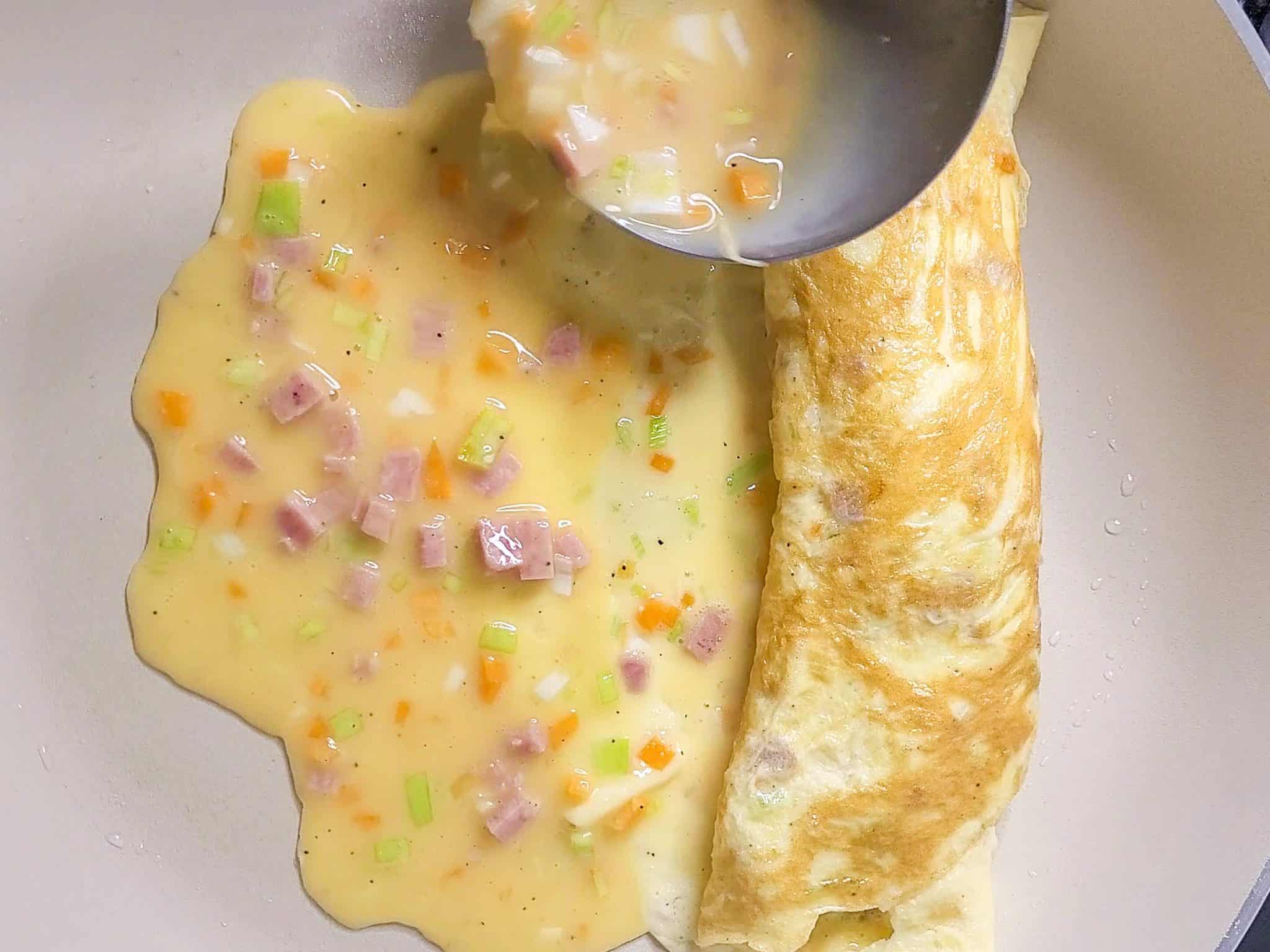 Ladle pouring raw egg into a pan
