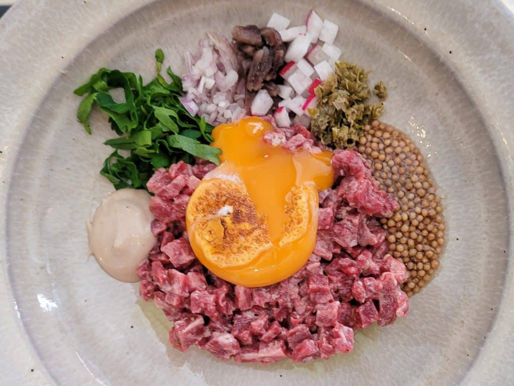 Beef Tartare with broken egg yolk at O Frade