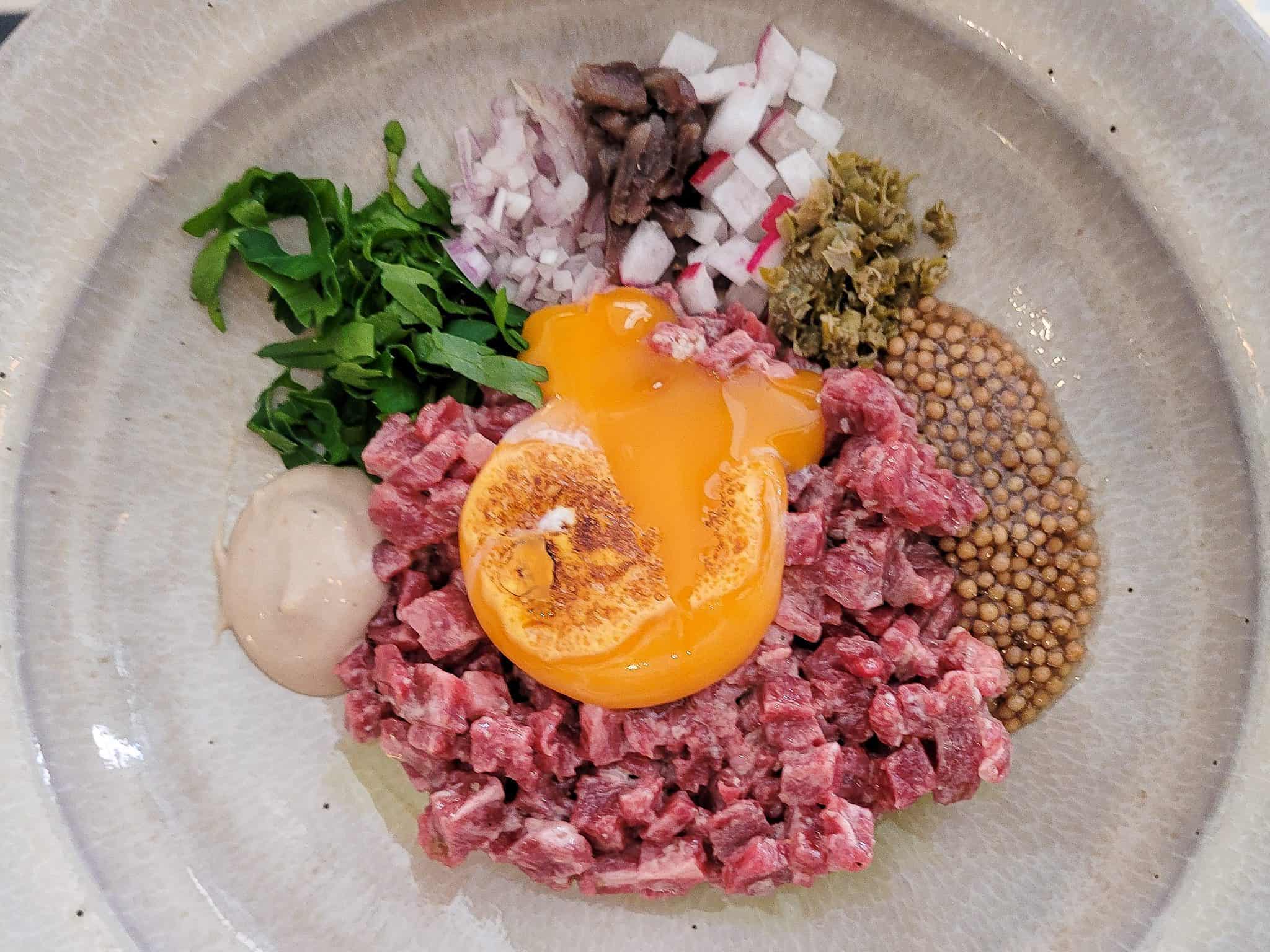 Beef Tartare with broken egg yolk at O Frade