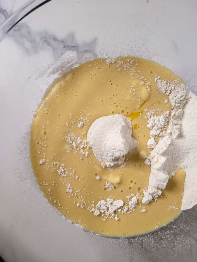 Wet and dry ingredients for ube mini buns in one bowl