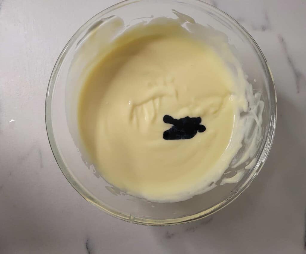 Ube extract in cream sauce in glass bowl