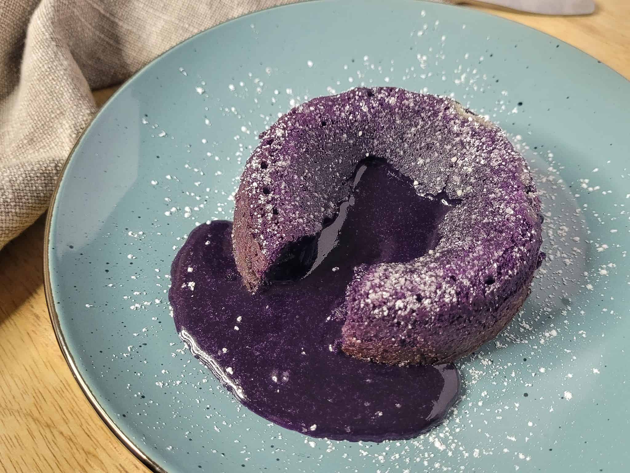 Closeup of ube lava cake on a blue plate