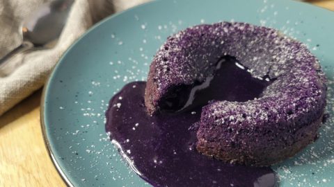Closeup of ube lava cake on a blue plate