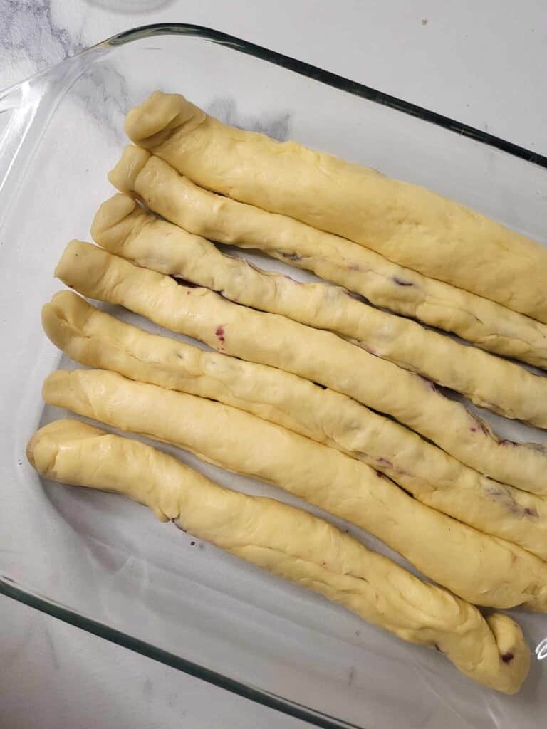Strips of dough in a glass baking dish