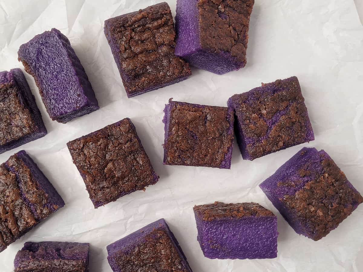 Ube butter mochi squares of different sizes