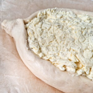 Cheese mixture inside a bowl made of dough