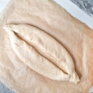 Fold over the sides of the raw dough and pinch the ends