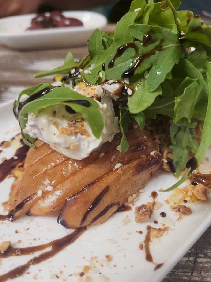 Closeup of grilled pear with blue cheese on a plate