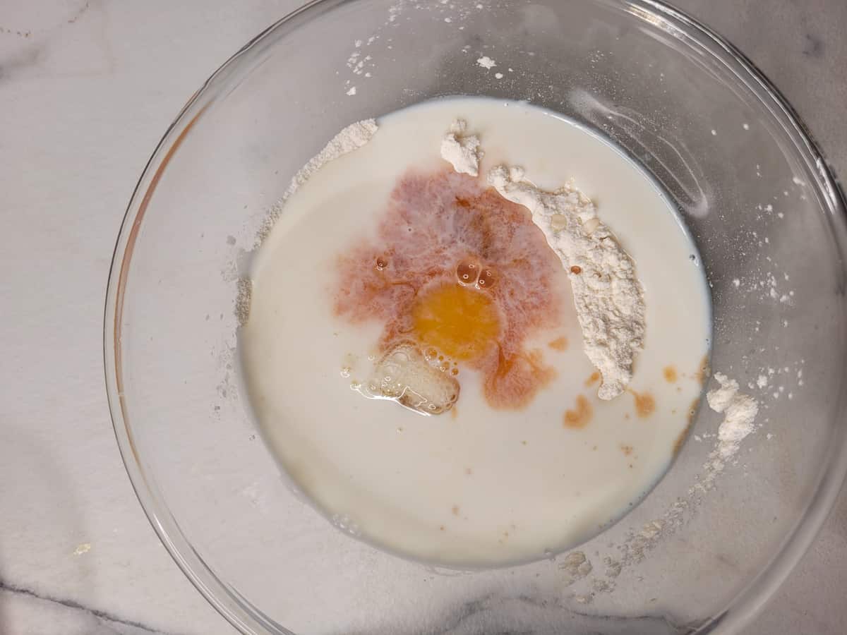 Dry and wet ingredients in a clear bowl