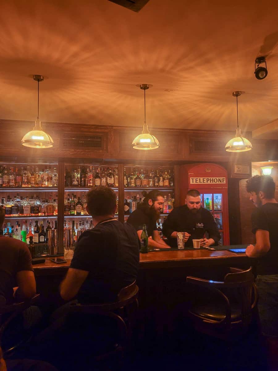 A bar with a telephone booth in the back
