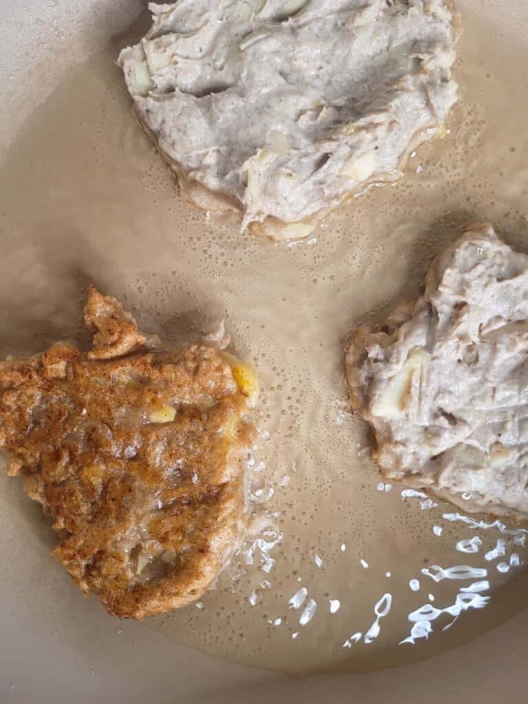 Filipino fritter frying in oil in a pan