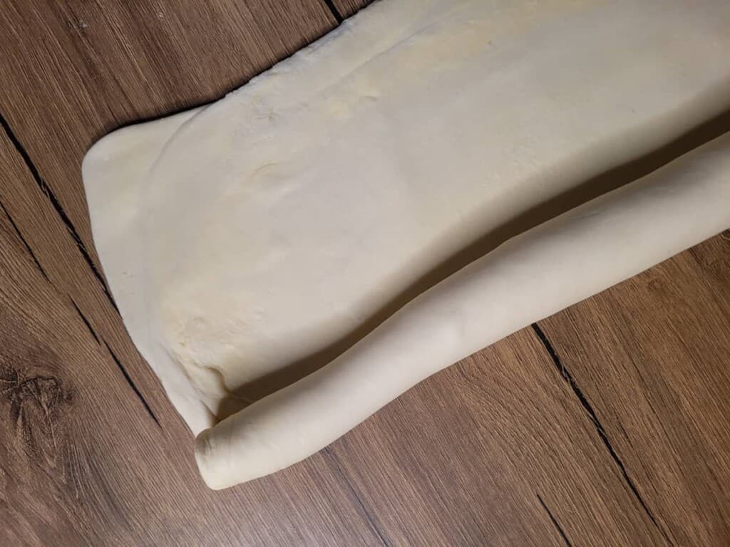 Pastry dough being rolled into a log