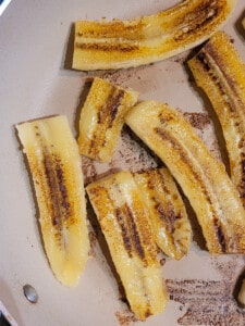 Sliced bananas fried in a pan