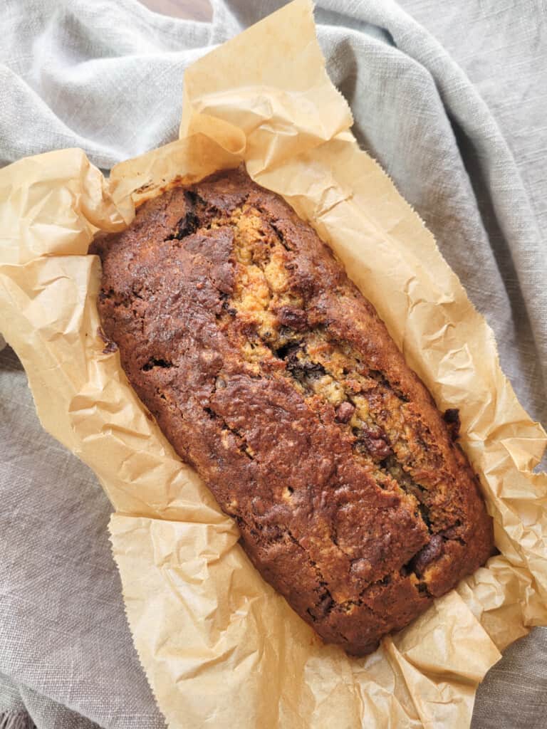 Caramelized banana bread on wax paper on top of gray towel