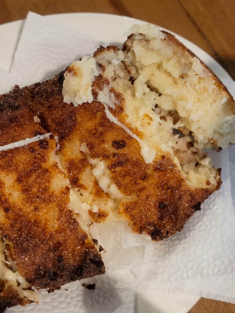 Sliced chvishtari or fried Georgian corn bread with cheese on paper towel