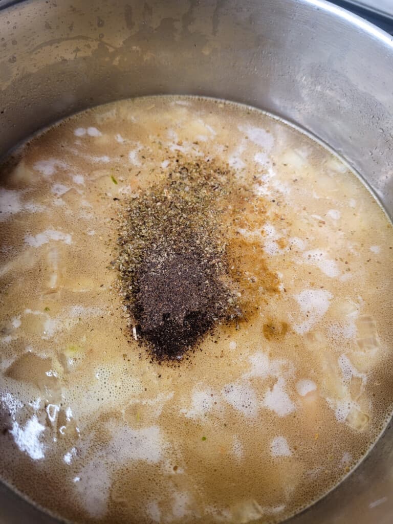 Seasonings in a česnečka or garlic soup in a pot