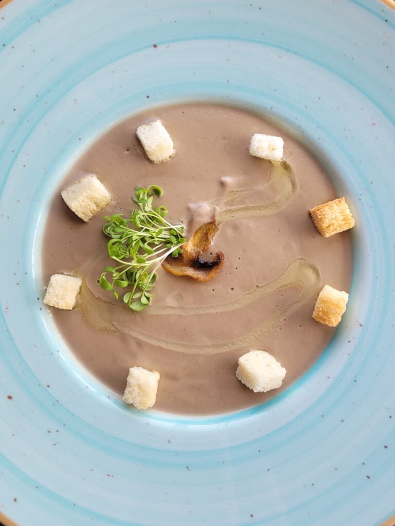 Creamy mushroom soup in a blue bowl