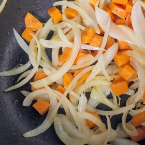 Carrots and onions cooked in a pot